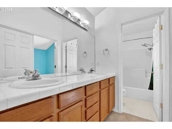 a bathroom with a sink and a mirror with bathtub
