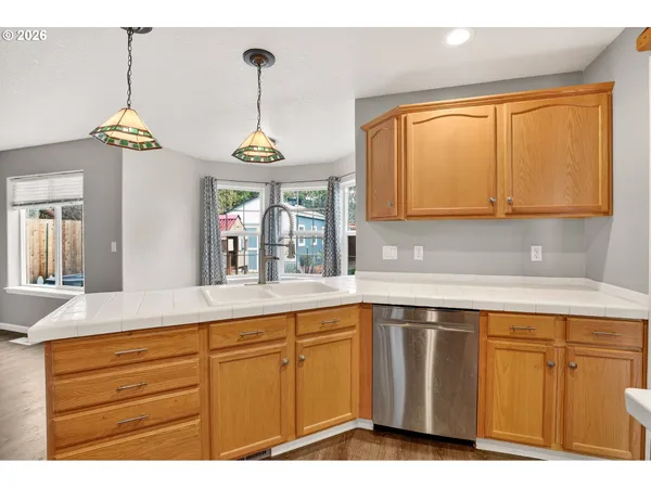 a kitchen with wooden cabinets and center island