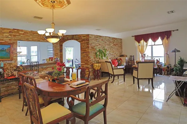 a view of a dining room with furniture and a chandelier