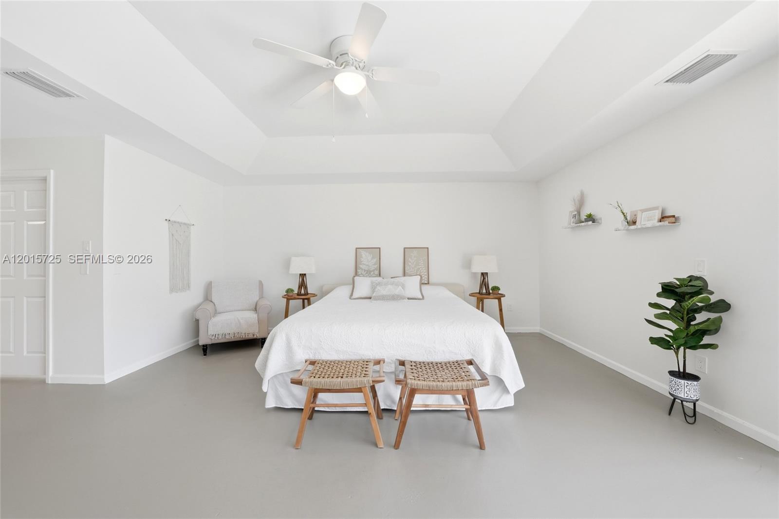 11008 Boca Woods Lane Boca Raton, FL 33428 - Photo 14 of 70 a bedroom with a bed and a chandelier