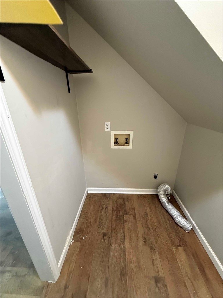 116 Kelly Lane Easley, SC 29642 - Photo 7 of 39 Functional laundry nook features durable wood-look flooring and built-in shelving beneath a sloped ceiling. In the hallway to the garage