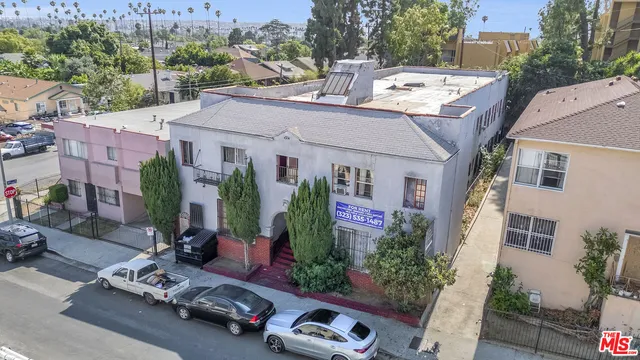 a view of a patio with table and chairs potted plants