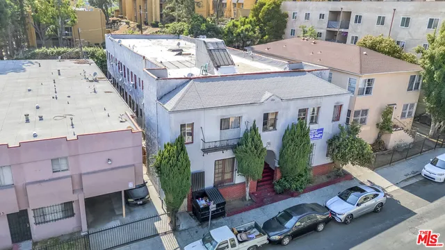 an aerial view of a house with backyard