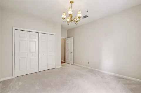 a view of an empty room with a chandelier