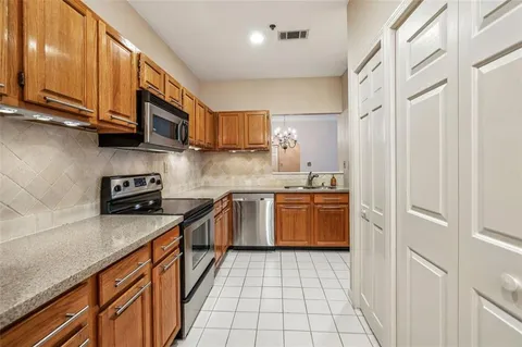 a kitchen with stainless steel appliances granite countertop a sink stove and microwave