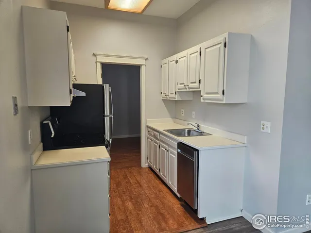 a kitchen with a refrigerator and a window