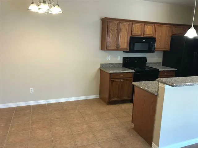 a kitchen with cabinets and steel appliances