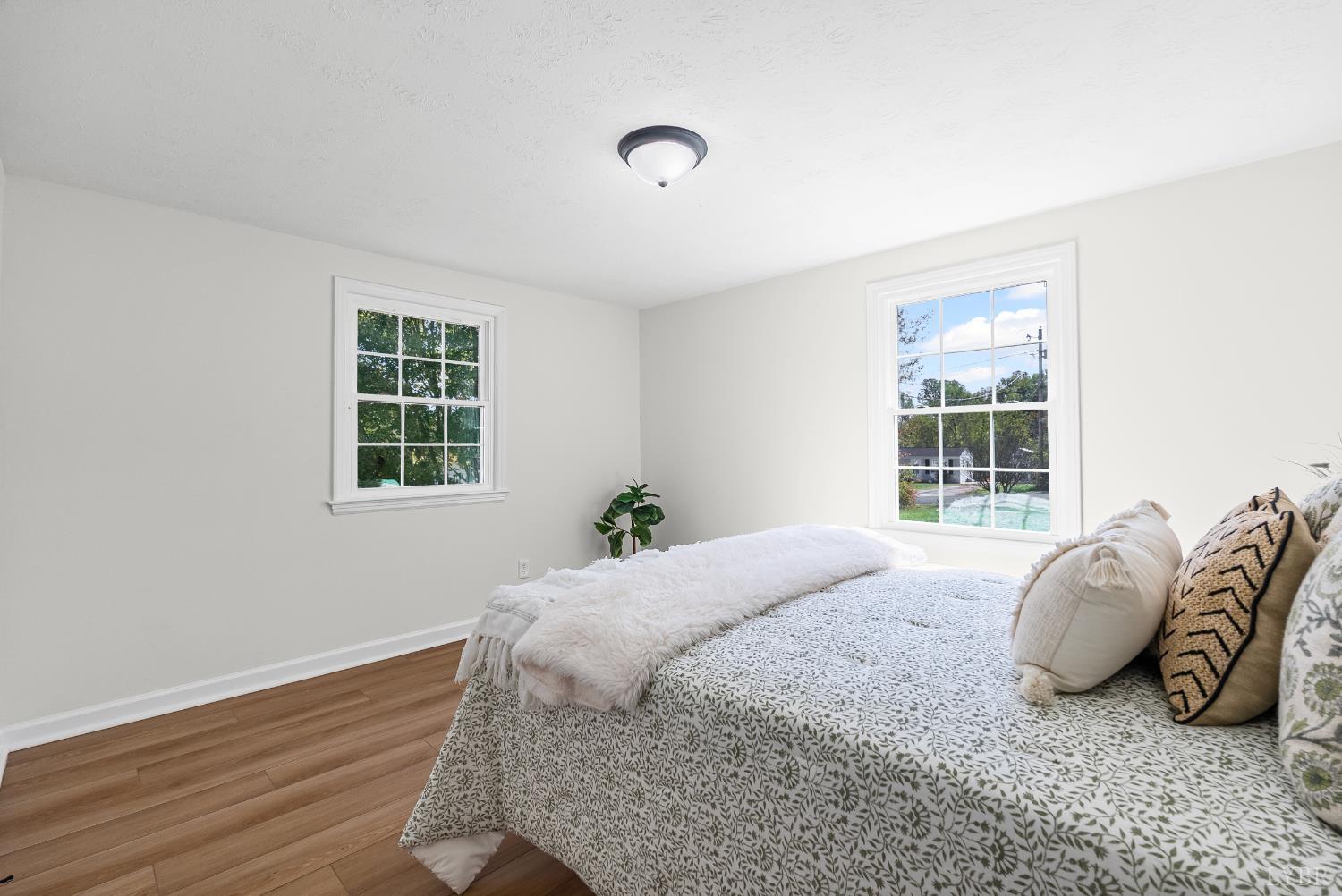 202 Ridgecrest Drive Monroe, VA 24574 - Photo 14 of 25 a bed sitting in a spacious bedroom next to a window and a window