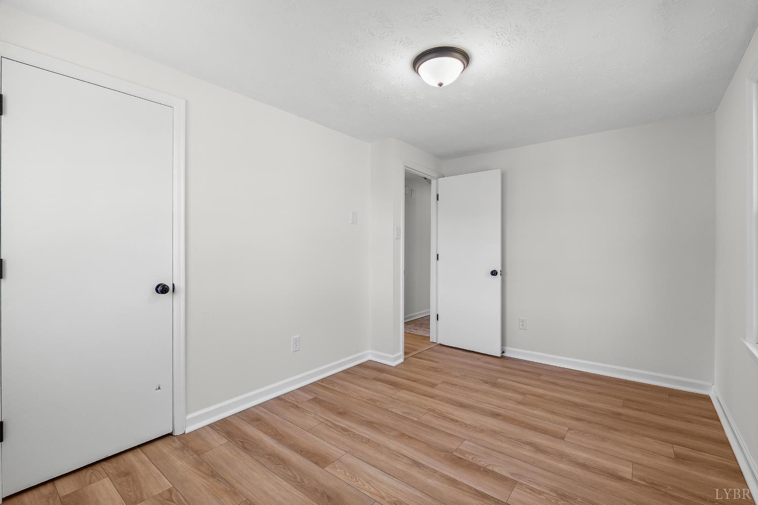 202 Ridgecrest Drive Monroe, VA 24574 - Photo 17 of 25 a view of room with wooden floor