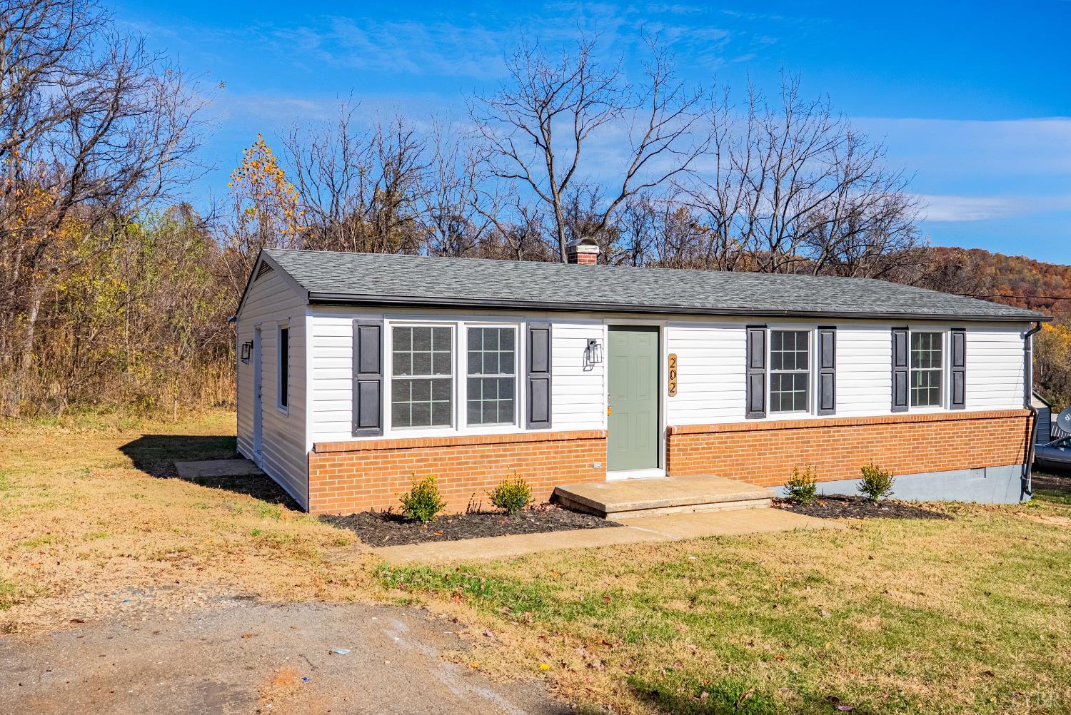202 Ridgecrest Drive Monroe, VA 24574 - Photo 2 of 25 a front view of a house with a yard covered with snow in front of house