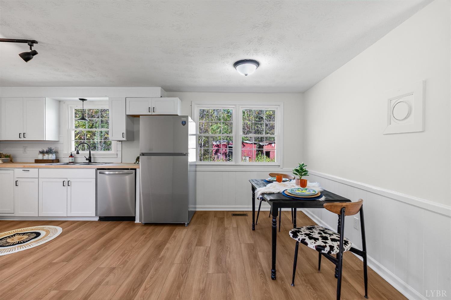 202 Ridgecrest Drive Monroe, VA 24574 - Photo 6 of 25 a kitchen with a refrigerator and a table
