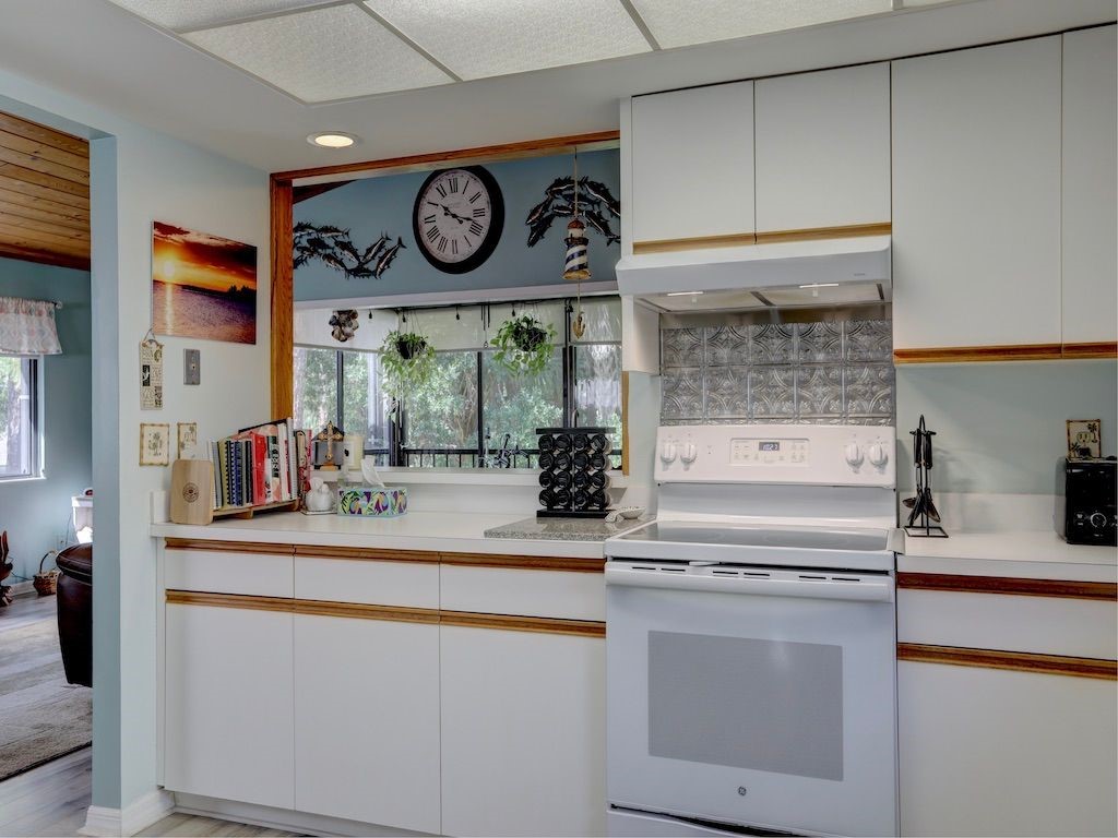 2150 Pine Creek Boulevard, Unit 202 Vero Beach, FL 32966 - Photo 13 of 31 a kitchen with stainless steel appliances granite countertop a stove and a sink