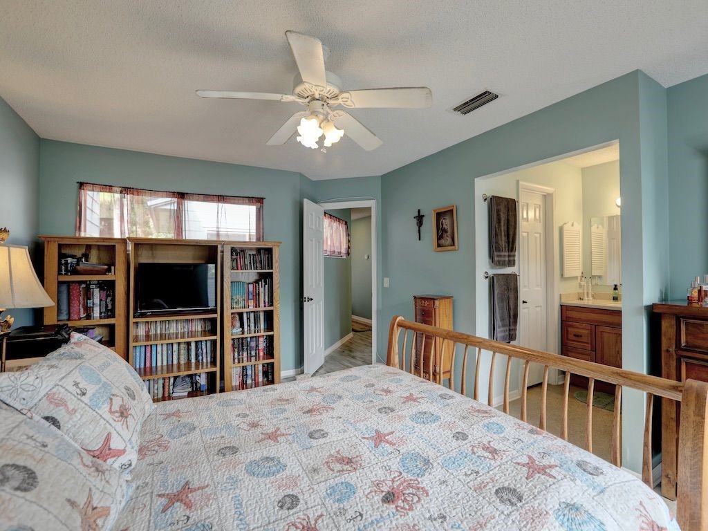 2150 Pine Creek Boulevard, Unit 202 Vero Beach, FL 32966 - Photo 17 of 31 a bedroom with furniture and a flat screen tv