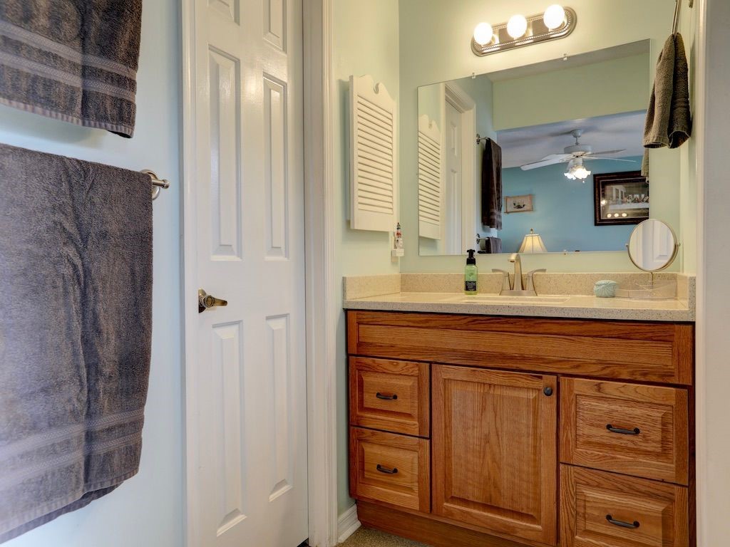 2150 Pine Creek Boulevard, Unit 202 Vero Beach, FL 32966 - Photo 18 of 31 a bathroom with a sink vanity granite and a mirror