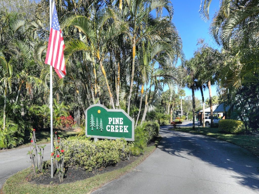 2150 Pine Creek Boulevard, Unit 202 Vero Beach, FL 32966 - Photo 26 of 31 a sign that is sitting on a sidewalk in front of house