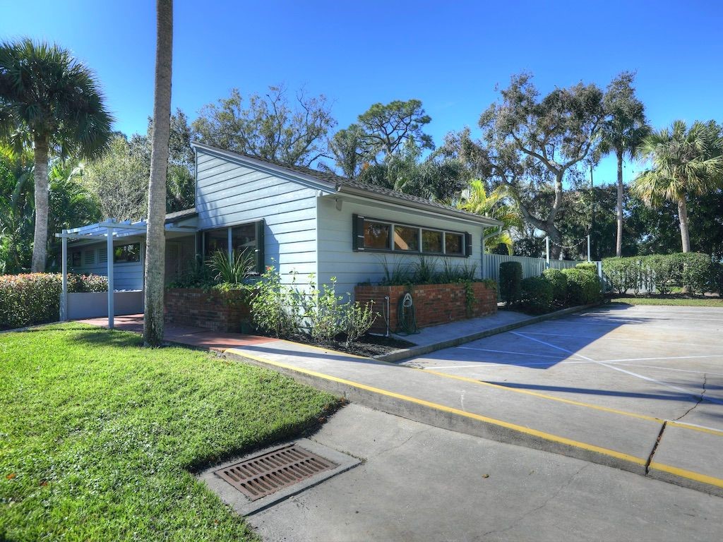 2150 Pine Creek Boulevard, Unit 202 Vero Beach, FL 32966 - Photo 28 of 31 front view of a house with a yard