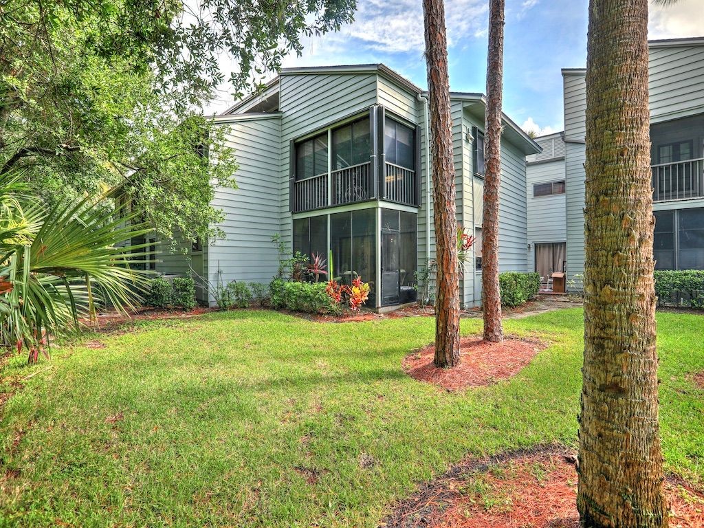 2150 Pine Creek Boulevard, Unit 202 Vero Beach, FL 32966 - Photo 4 of 31 a view of a house with backyard and a tree