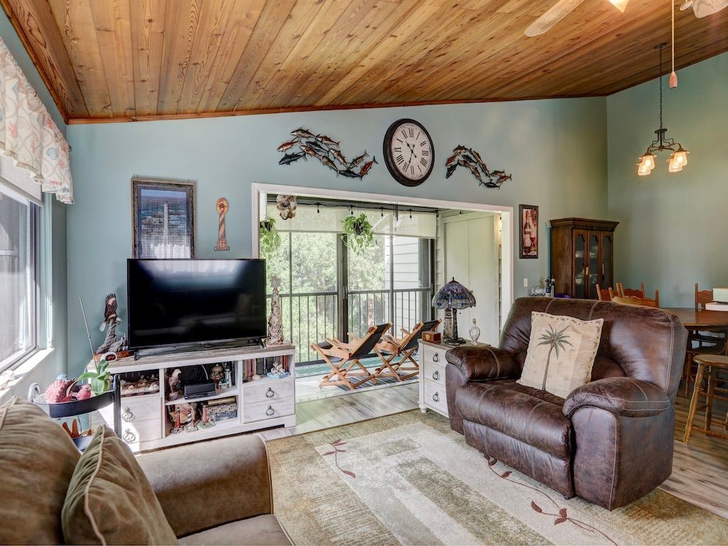2150 Pine Creek Boulevard, Unit 202 Vero Beach, FL 32966 - Photo 9 of 31 a living room with furniture and a flat screen tv