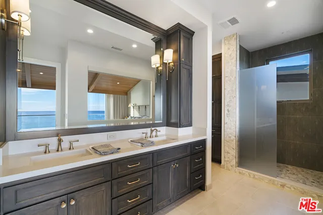 a bathroom with a sink double vanity and a shower