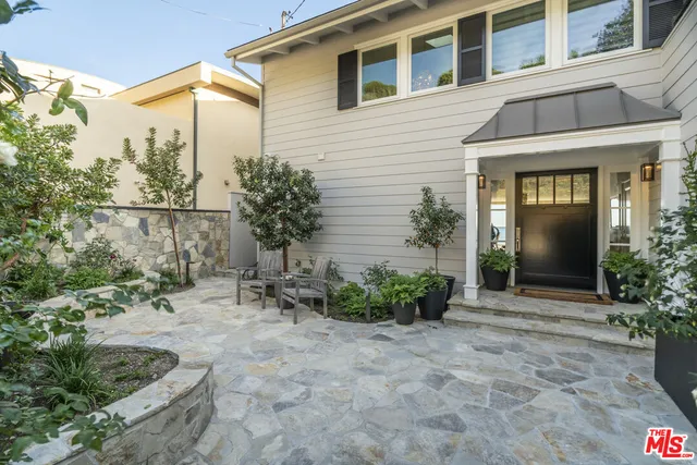 a view of a chair and table in the backyard of the house