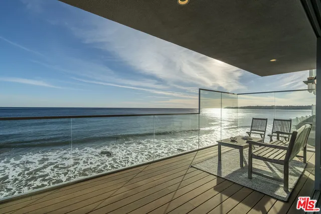 a view of a room with wooden floor and outdoor seating