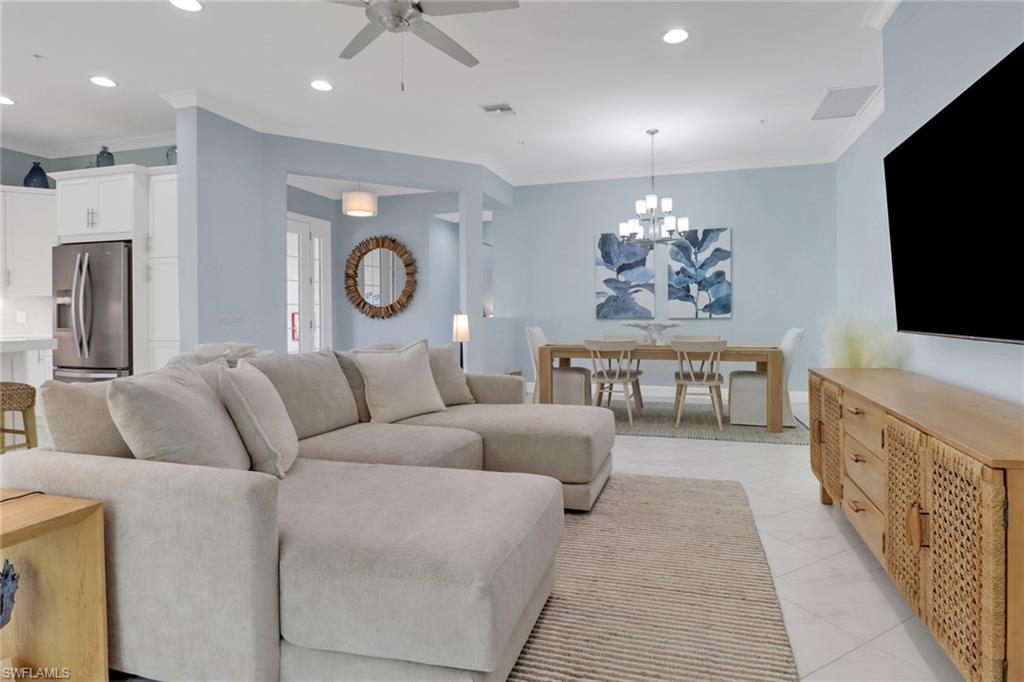 6509 Dominica Drive, Unit 101 Naples, FL 34113 - Photo 8 of 33 a living room with furniture and a flat screen tv