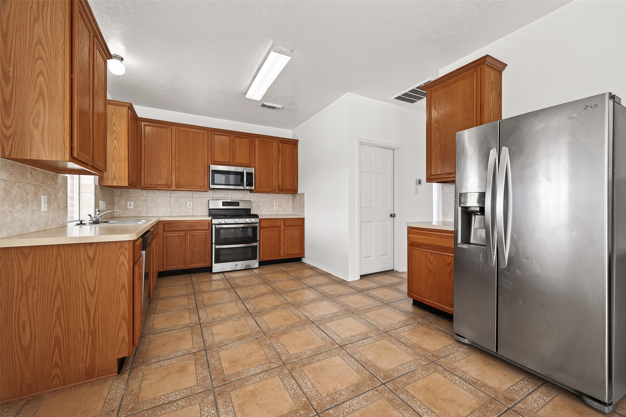 18807 Forest Deer Road Houston, TX 77084 - Photo 12 of 29 a kitchen with stainless steel appliances granite countertop a refrigerator sink and stove
