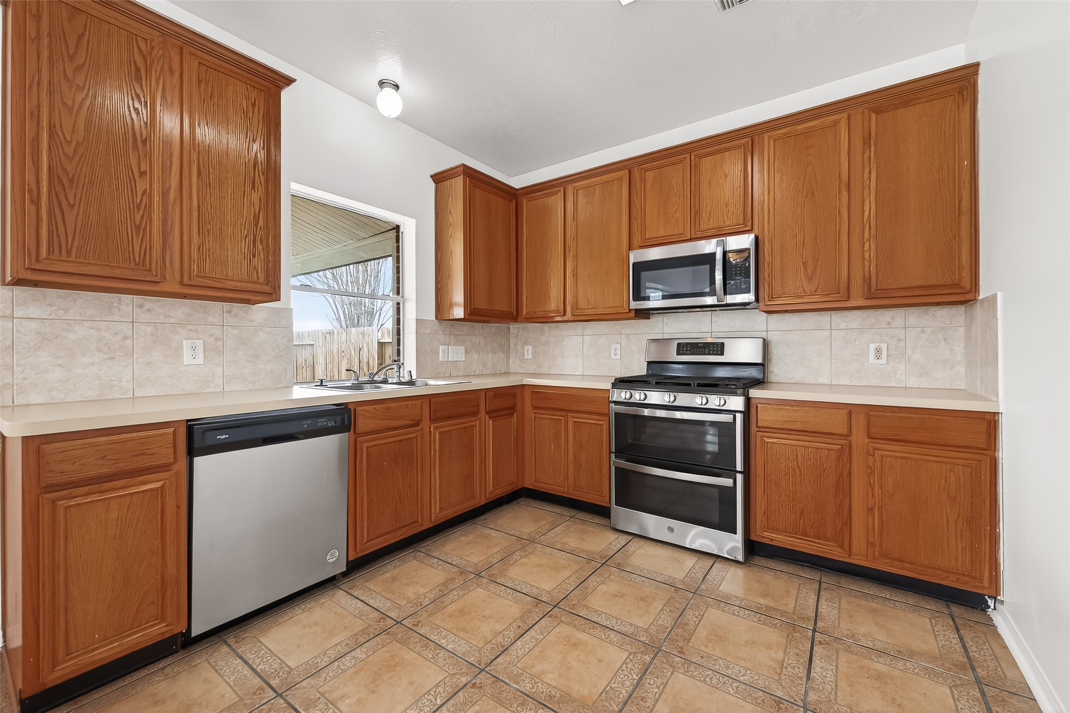 18807 Forest Deer Road Houston, TX 77084 - Photo 13 of 29 a kitchen with stainless steel appliances granite countertop a stove microwave and sink