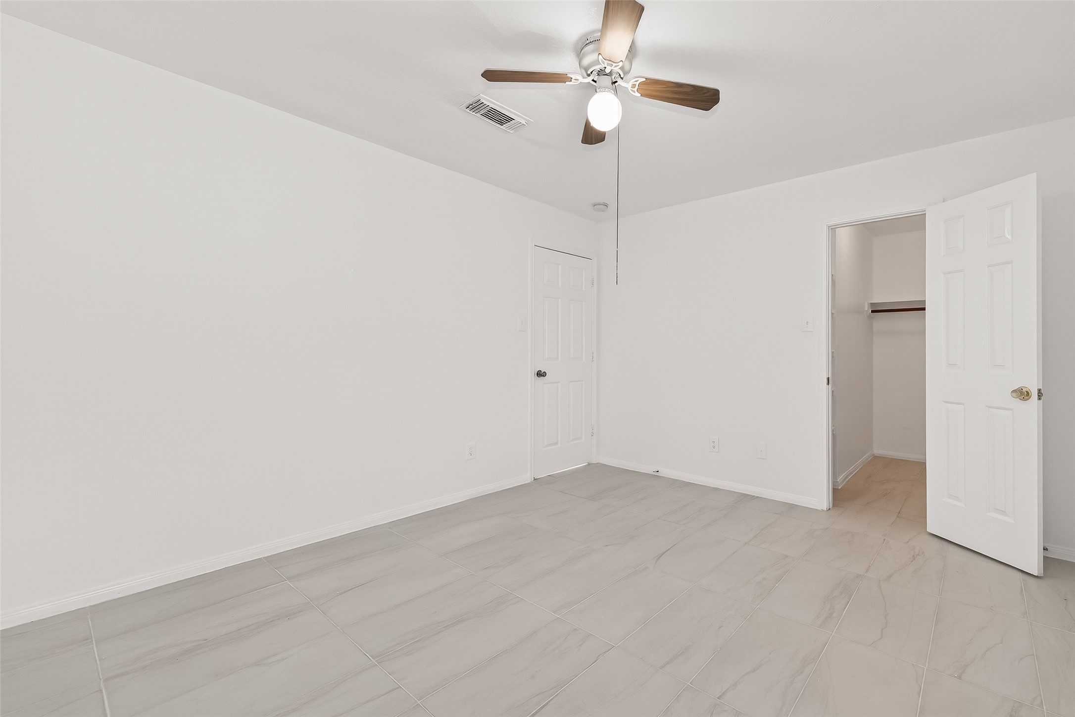 18807 Forest Deer Road Houston, TX 77084 - Photo 16 of 29 a view of an empty room with a fan