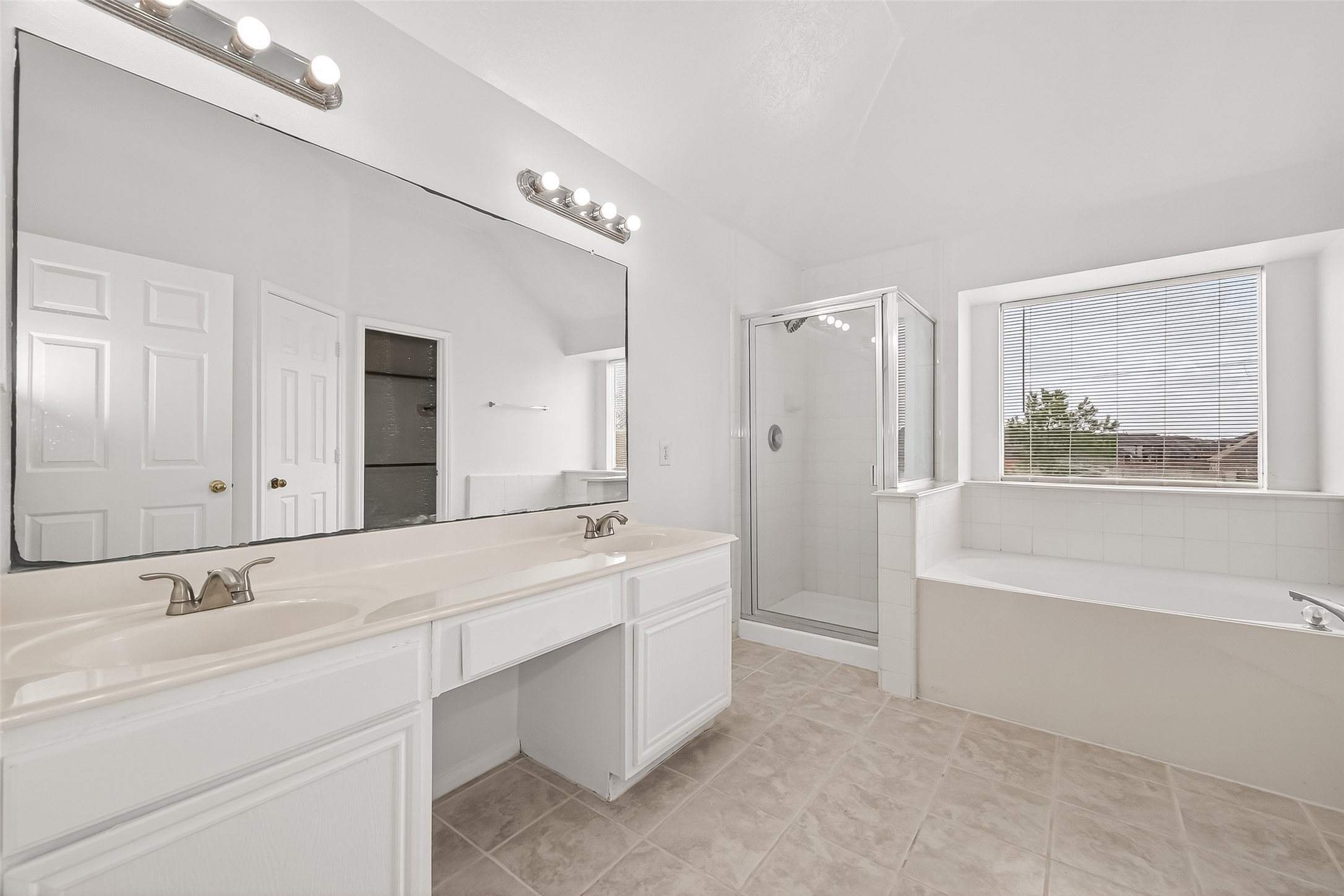 18807 Forest Deer Road Houston, TX 77084 - Photo 24 of 29 a spacious bathroom with a tub sink and mirror