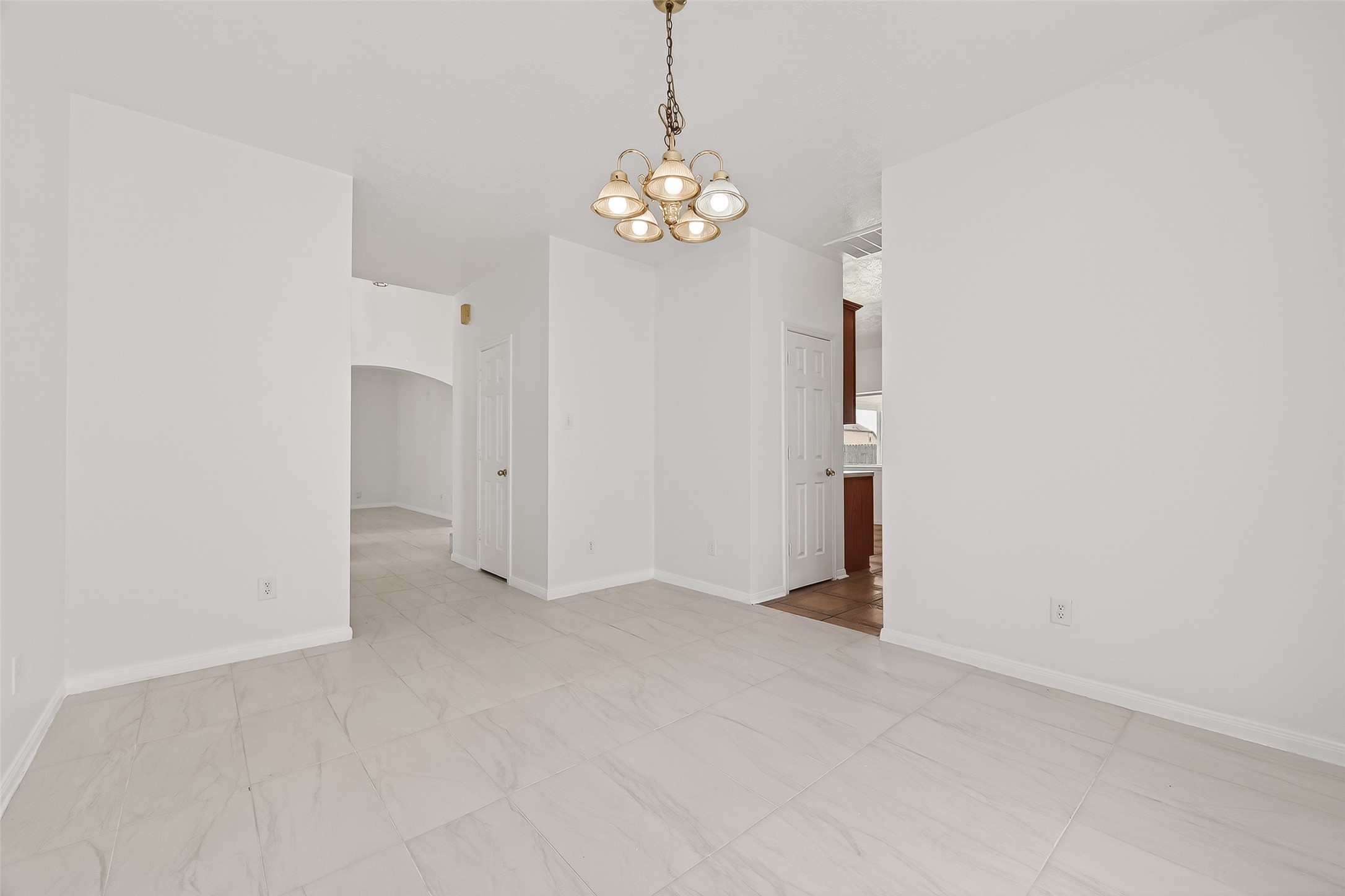 18807 Forest Deer Road Houston, TX 77084 - Photo 9 of 29 a view of an empty room with chandelier and fire place