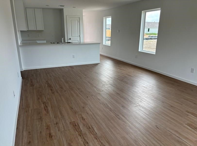 654 Maria Elena Way Cleveland, TX 77327 - Photo 4 of 23 a view of kitchen with window and wooden floor