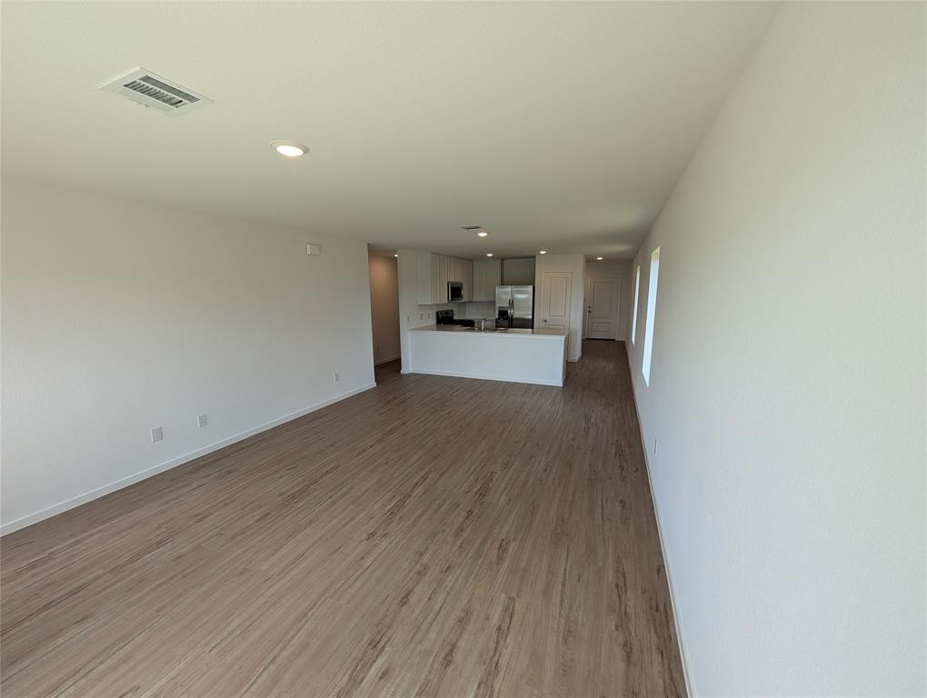 654 Maria Elena Way Cleveland, TX 77327 - Photo 8 of 23 a view of a kitchen with a sink and wooden floor