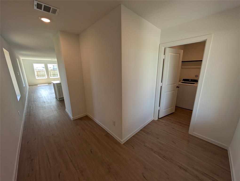 654 Maria Elena Way Cleveland, TX 77327 - Photo 10 of 23 wooden floor in an empty room with a window