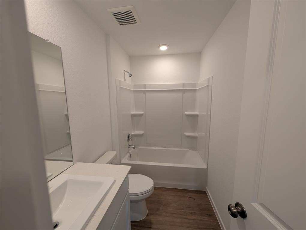 654 Maria Elena Way Cleveland, TX 77327 - Photo 11 of 23 a bathroom with a toilet and shower