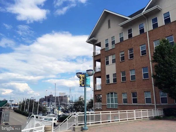 a front view of a residential apartment building with a yard
