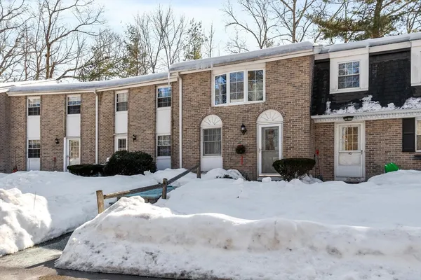 a view of a house with a yard covered in snow