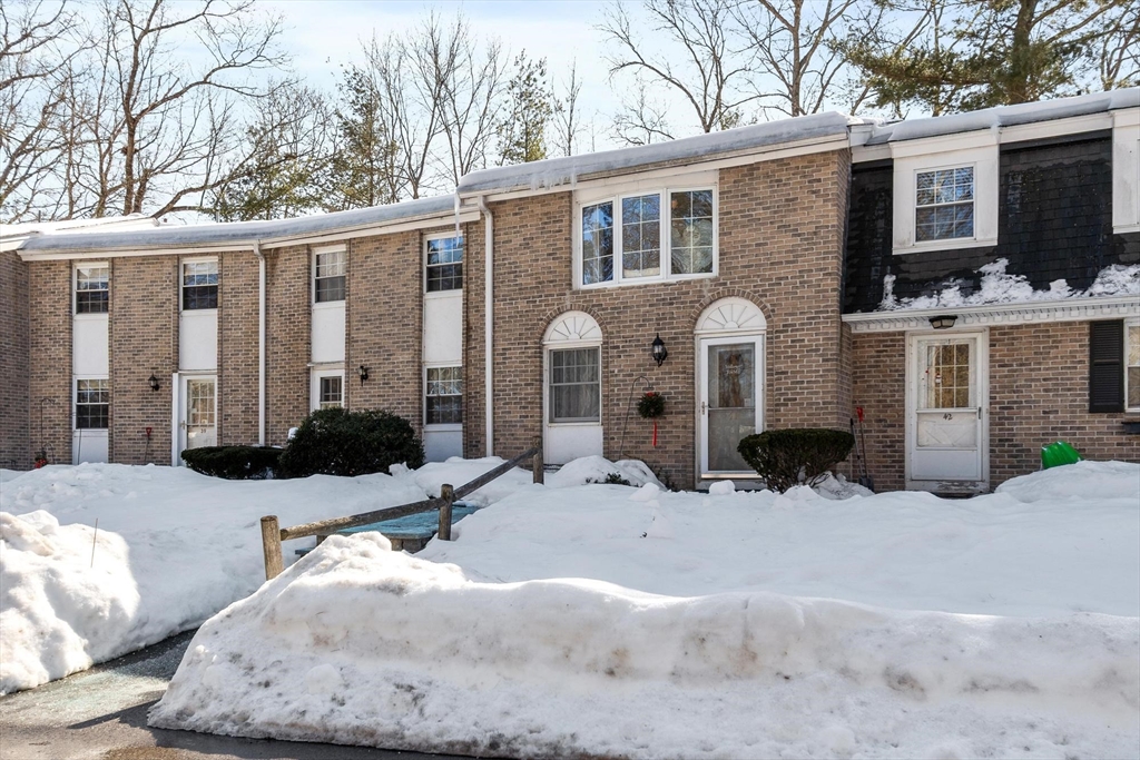 a view of a house with a yard covered in snow