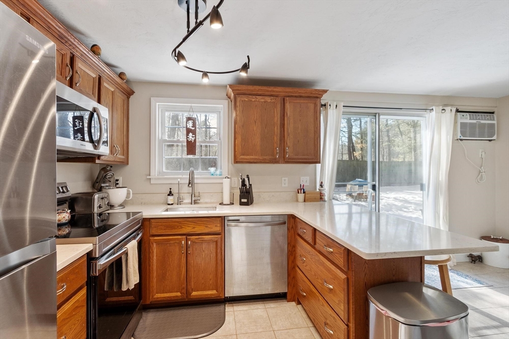 75 Sandy Pond Road, Unit 41 Ayer, MA 01432 - Photo 15 of 36 a kitchen with a sink stove and cabinets