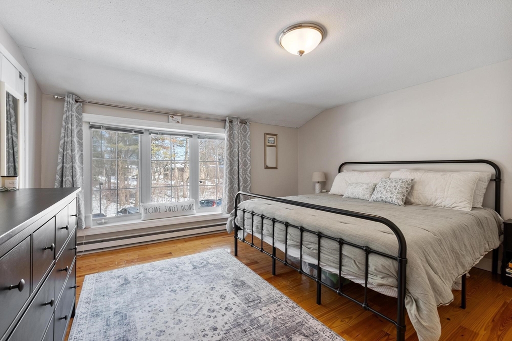 75 Sandy Pond Road, Unit 41 Ayer, MA 01432 - Photo 23 of 36 a bedroom with a bed and a large window