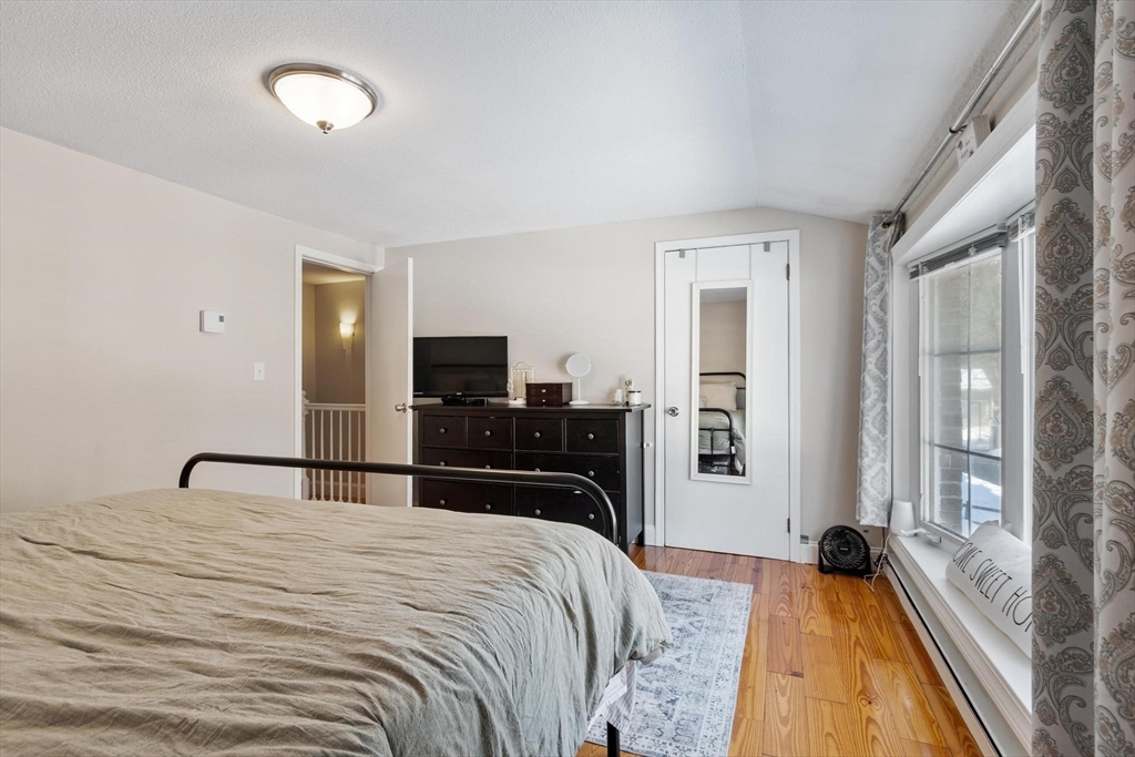 75 Sandy Pond Road, Unit 41 Ayer, MA 01432 - Photo 24 of 36 a bedroom with a bed and a large window with outer view
