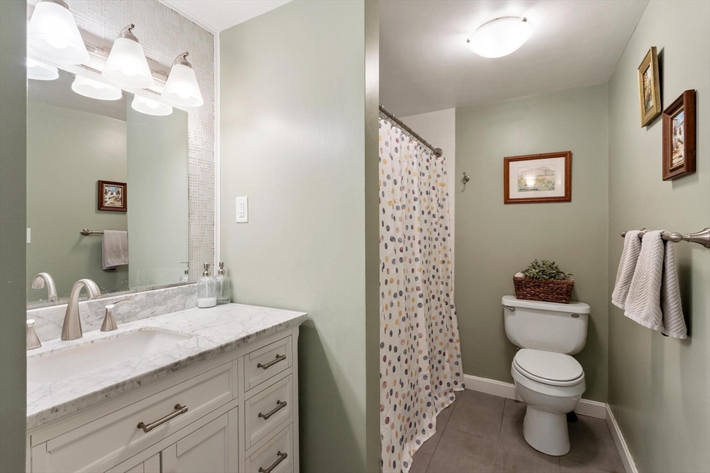 75 Sandy Pond Road, Unit 41 Ayer, MA 01432 - Photo 26 of 36 a bathroom with a toilet a sink and a mirror