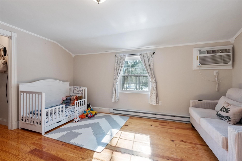 75 Sandy Pond Road, Unit 41 Ayer, MA 01432 - Photo 27 of 36 a living room with furniture and a baby crib