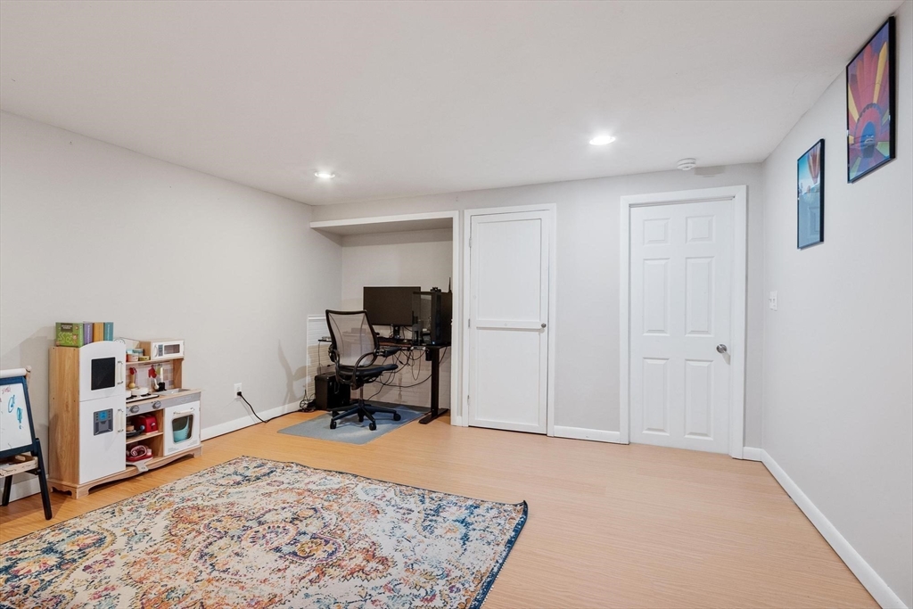 75 Sandy Pond Road, Unit 41 Ayer, MA 01432 - Photo 32 of 36 a room with furniture and a book shelf