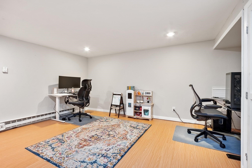 75 Sandy Pond Road, Unit 41 Ayer, MA 01432 - Photo 33 of 36 a view of a workspace with furniture and a rug