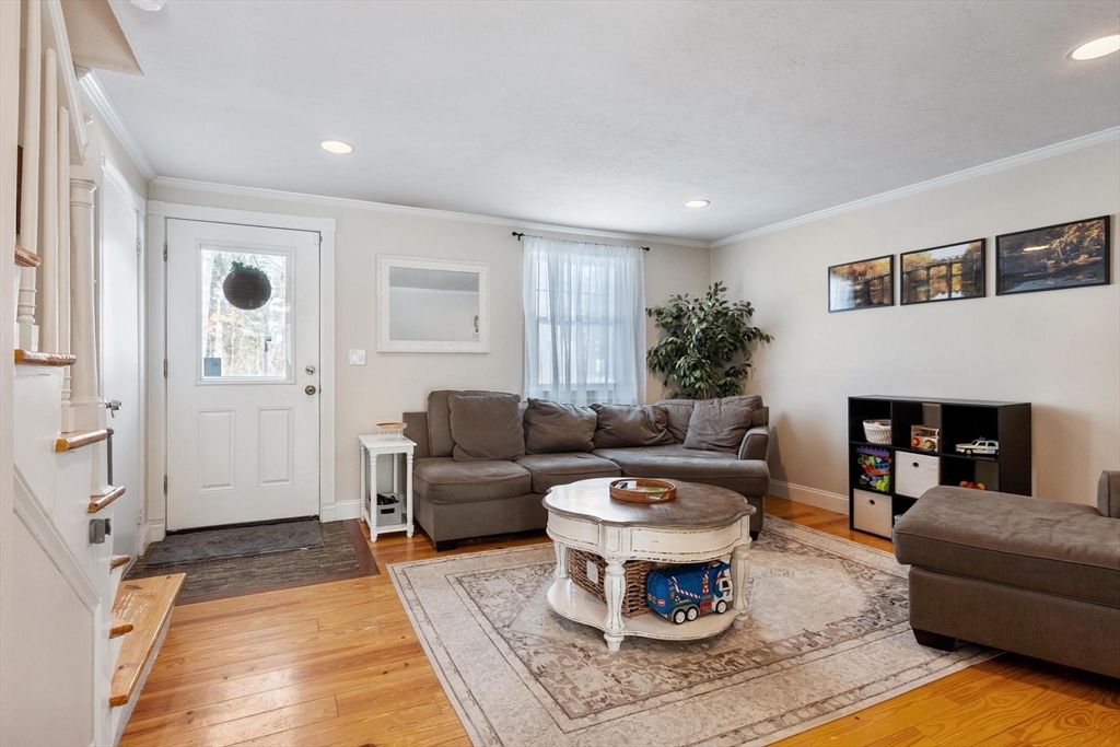 75 Sandy Pond Road, Unit 41 Ayer, MA 01432 - Photo 5 of 36 a living room with furniture a rug and a fireplace