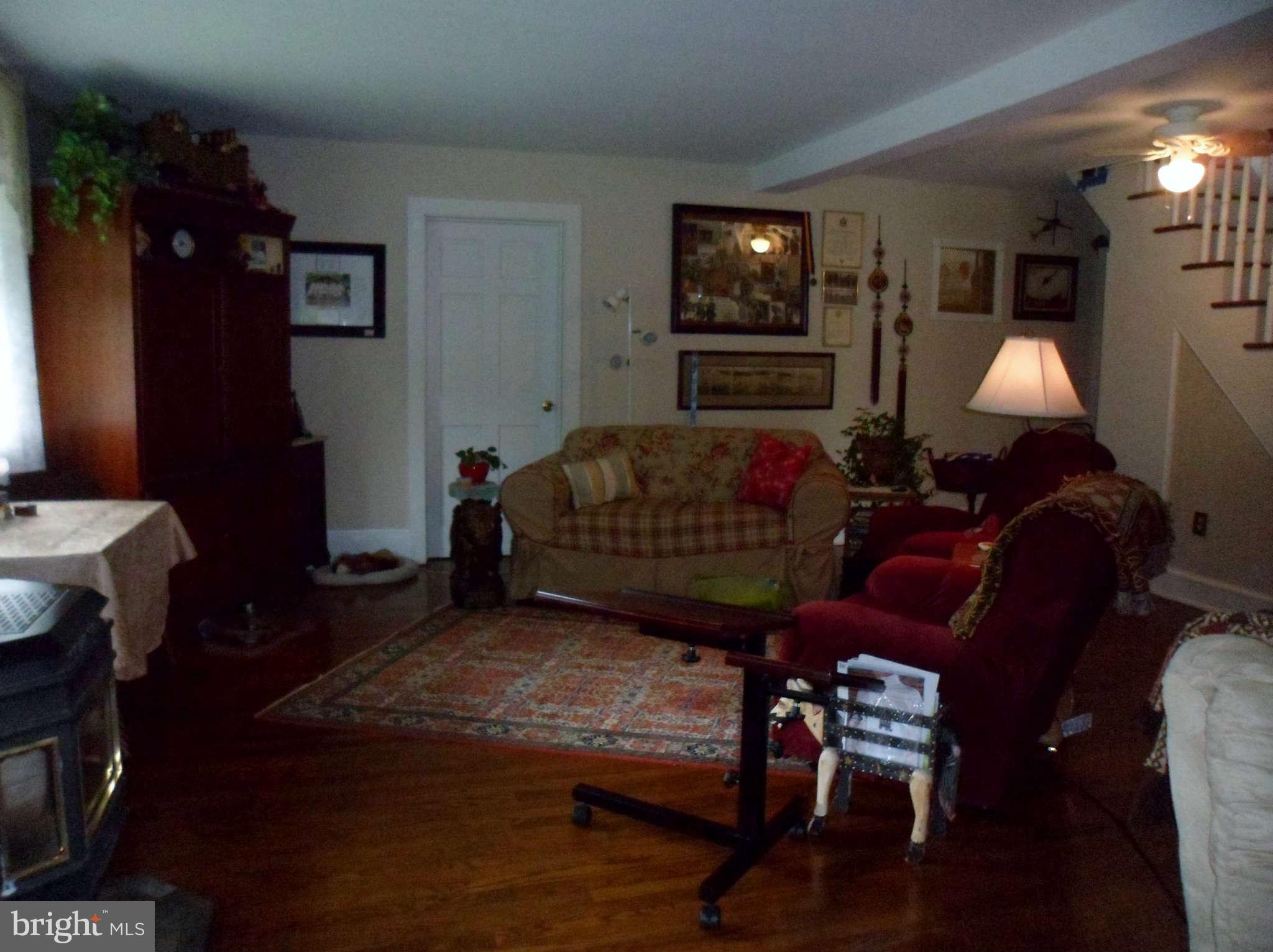 2990 Sixes Road Prince Frederick, MD 20678 - Photo 18 of 30 a living room with furniture a flat screen tv and a lamp