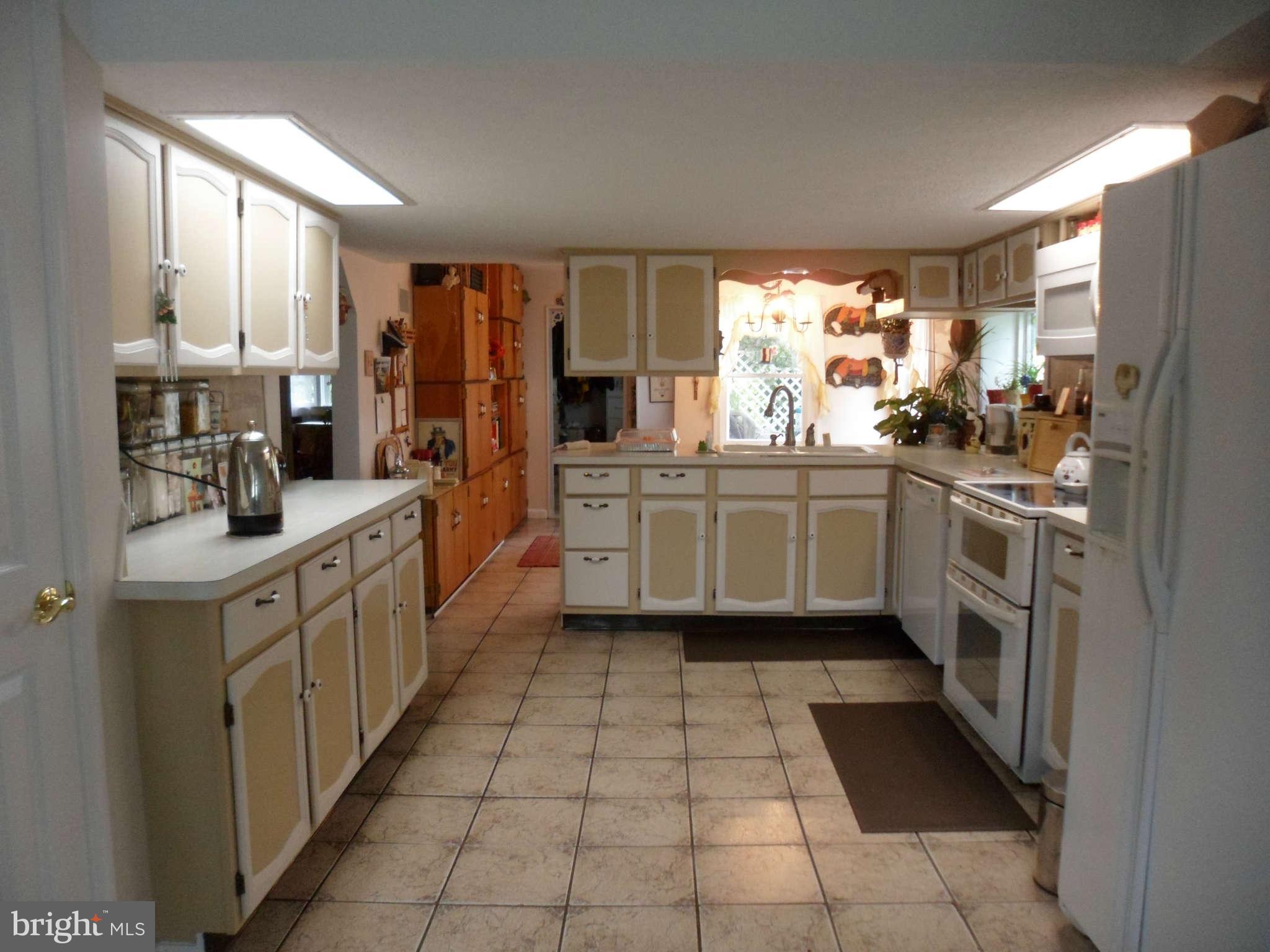 2990 Sixes Road Prince Frederick, MD 20678 - Photo 22 of 30 a kitchen with stainless steel appliances a sink counter space and a window