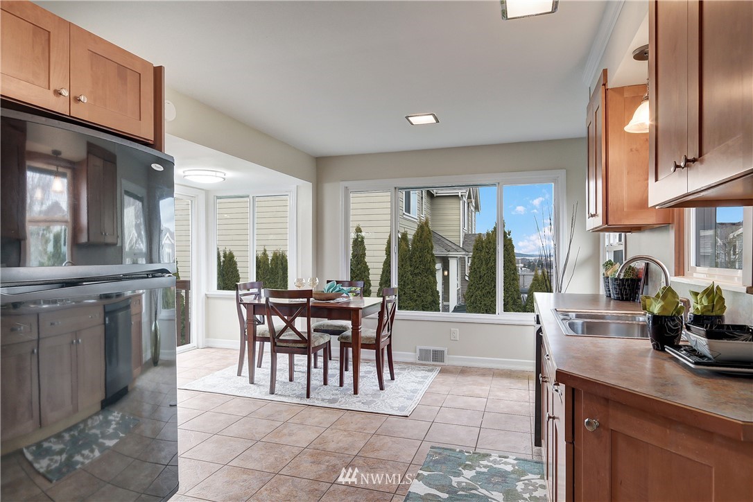 306 South 15th Street Renton, WA 98055 - Photo 13 of 22 a dining hall with stainless steel appliances a stove a sink a dining table and chairs