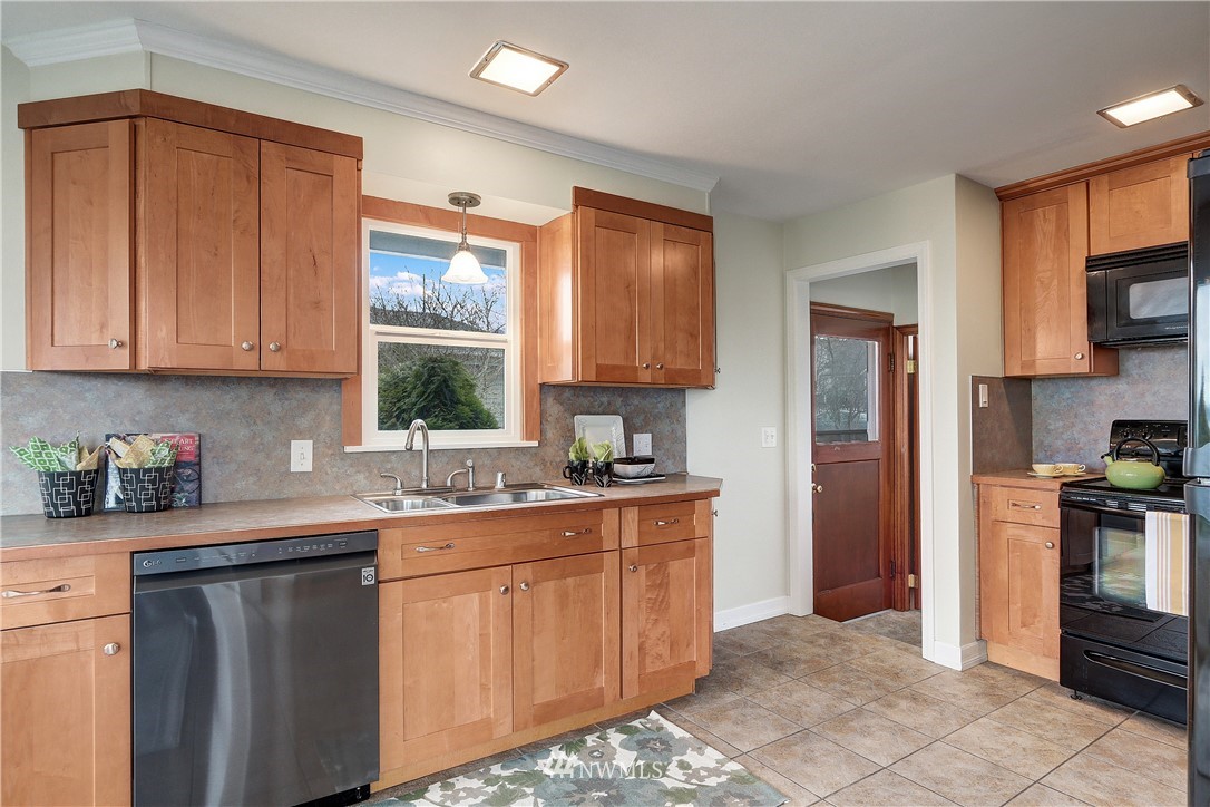 306 South 15th Street Renton, WA 98055 - Photo 14 of 22 a kitchen with stainless steel appliances granite countertop a refrigerator sink and cabinets